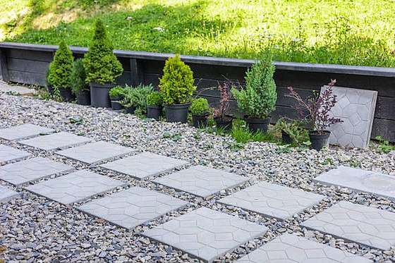 Hexagon paving slabs set in gravel with potted conifers, Lynnwood