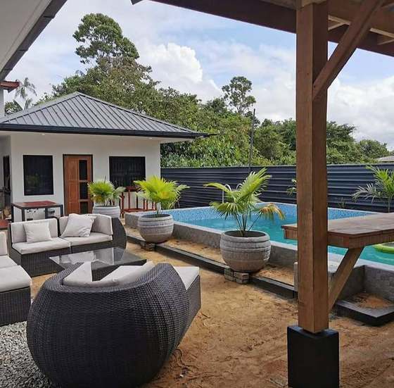 Pool and covered patio with lounge seating and palms, Lynnwood