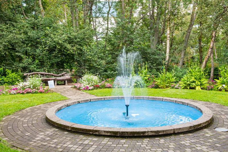 Round garden fountain with brick paving surround, Midstream Estate